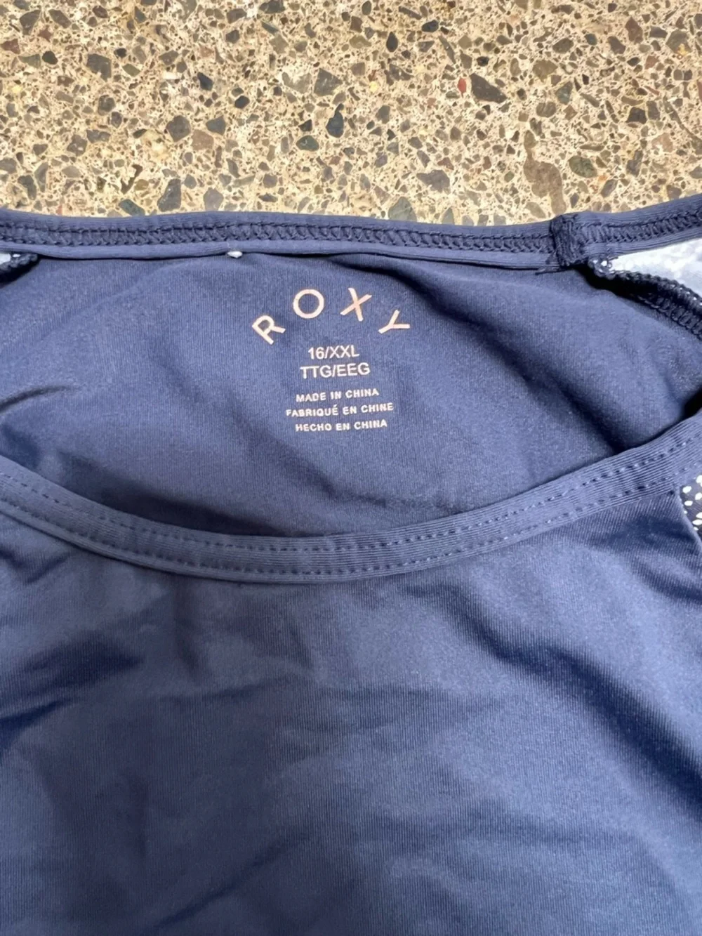 Roxy rashguard in blue with white floral design at sleeves